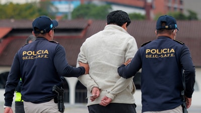 A person is taken in handcuffs after arriving on a repatriation flight from the United States at La Aurora International Airport in Guatemala City, Guatemala, June 26, 2025. (Reuters)