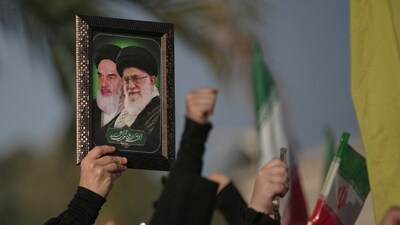 A Hezbollah supporter holds a portrait of the late revolutionary founder Ayatollah Khomeini, left, and Supreme Leader Ayatollah Ali Khamenei, during a gathering outside the Iranian Embassy in Beirut, Lebanon, Wednesday, June 25, 2025. (AP) A Hezbollah supporter holds a portrait of the late revolutionary founder Ayatollah Khomeini, left, and Supreme Leader Ayatollah Ali Khamenei, during a gathering outside the Iranian Embassy in Beirut, Lebanon, Wednesday, June 25, 2025. (AP)