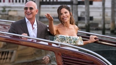 Jeff Bezos, left, and Lauren Sanchez leave a hotel for their pre-wedding reception, in Venice (AP) Jeff Bezos, left, and Lauren Sanchez leave a hotel for their pre-wedding reception, in Venice (AP)