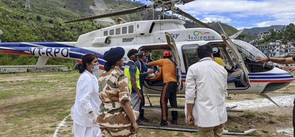 Two injured passengers being airlifted to AIIMS Rishikesh by a helicopter after a 31-seater bus carrying pilgrims fell into the Alakananda River in Rudraprayag district. (PTI)