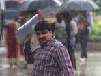 People walking in heavy rain in Mumbai's Bandra on Thursday, June 26.
