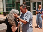 Crystina Page, right, hugs Beth Mosley after a Colorado funeral home owner who stashed nearly 190 decomposing bodies was sentenced to 20 years prison on federal fraud charges. Crystina Page, right, hugs Beth Mosley after a Colorado funeral home owner who stashed nearly 190 decomposing bodies was sentenced to 20 years prison on federal fraud charges.