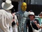 Lifelike statues of Jeff Bezos, especially one covered in fake dollar bills, have become tourist attractions in Venice. Click News/Handout via REUTERS    