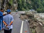 People look at a partially caved in portion of a road, following rainfall at Manali, in Kullu district, Himachal Pradesh. People look at a partially caved in portion of a road, following rainfall at Manali, in Kullu district, Himachal Pradesh.