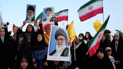 Iranian protesters hold their country's flags and posters of Supreme Leader Ayatollah Ali Khamenei in an anti-US and anti-Israeli rally in Tehran. (AP) Iranian protesters hold their country's flags and posters of Supreme Leader Ayatollah Ali Khamenei in an anti-US and anti-Israeli rally in Tehran. (AP)