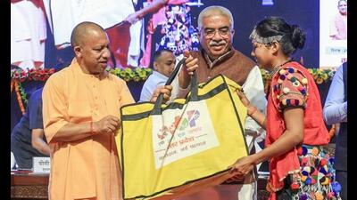 Chief minister Yogi presents toolkit to a beneficiary of ‘One District, One Product’ scheme during the curtain raiser ceremony of the third edition of the UP International Trade Show (UPITS) on the occasion of International MSME Day, at Lok Bhavan, in Lucknow, Friday. (PTI Photo) Chief minister Yogi presents toolkit to a beneficiary of ‘One District, One Product’ scheme during the curtain raiser ceremony of the third edition of the UP International Trade Show (UPITS) on the occasion of International MSME Day, at Lok Bhavan, in Lucknow, Friday. (PTI Photo)