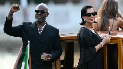 Corey Gamble and Kris Jenner stand on a taxi boat as they leave the Gritti Palace Hotel ahead of the wedding of Amazon's founder Jeff Bezos with Lauren Sanchez in Venice on June 26, 2026. (AFP) Corey Gamble and Kris Jenner stand on a taxi boat as they leave the Gritti Palace Hotel ahead of the wedding of Amazon's founder Jeff Bezos with Lauren Sanchez in Venice on June 26, 2026. (AFP)