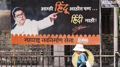 Mumbai: Commuters pass by a newly put-up poster of Maharashtra Navnirman Sena (MNS) president Raj Thackeray that reads - "We are Hindus, but not Hindi", near Shiv Sena Bhavan, at Dadar, in Mumbai, Friday, April 18, 2025. The Maharashtra government has decided that Hindi as a third language would be mandatory for students in classes 1 to 5 in Marathi and English-medium schools across the state, in a departure from the practice of studying two languages. (PTI Photo/Kunal Patil) (PTI04_18_2025_000078B) (PTI) Mumbai: Commuters pass by a newly put-up poster of Maharashtra Navnirman Sena (MNS) president Raj Thackeray that reads - "We are Hindus, but not Hindi", near Shiv Sena Bhavan, at Dadar, in Mumbai, Friday, April 18, 2025. The Maharashtra government has decided that Hindi as a third language would be mandatory for students in classes 1 to 5 in Marathi and English-medium schools across the state, in a departure from the practice of studying two languages. (PTI Photo/Kunal Patil) (PTI04_18_2025_000078B) (PTI)