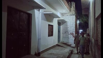 Police personnel during the raid at the house of the accused in Malihabad late on Thursday night. (HT Photo)