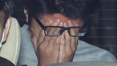 (FILES) This file photo taken on November 1, 2017 shows suspect Takahiro Shiraishi covering his face with his hands as he is transported to the prosecutor's office from a police station in Tokyo. (AFP) (FILES) This file photo taken on November 1, 2017 shows suspect Takahiro Shiraishi covering his face with his hands as he is transported to the prosecutor's office from a police station in Tokyo. (AFP)