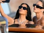 Bezos-Sanchez wedding:: US reality TV personality Kim Kardashian (L) and US socialite Khloe Kardashian snap a selfie as they arrive at San Giorgio Maggiore on the wedding day of Amazon founder Jeff Bezos with Lauren Sanchez, in Venice on June 27, 2025.  (Photo by Marco BERTORELLO / AFP)