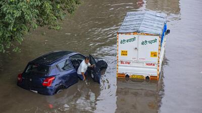 A car stuck on a waterlogged service road along the Delhi-Gurugram Expressway on June 17. (PTI) A car stuck on a waterlogged service road along the Delhi-Gurugram Expressway on June 17. (PTI)