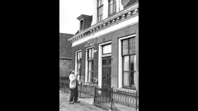 A knocker-upper uses a long pole to wake workers in the Netherlands. (Wikimedia) A knocker-upper uses a long pole to wake workers in the Netherlands. (Wikimedia)