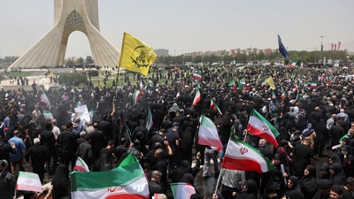 People attend the funeral procession of Iranian military commanders, nuclear scientists and others killed in Israeli strikes in Tehran. (Reuters)