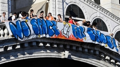 People hang a banner 'No Space for Bezos' on the Rialto Bridge during a protest a day after the wedding ceremony of Jeff Bezos and Lauren Sanchez in Venice, on June 28, 2025. (AFP) People hang a banner 'No Space for Bezos' on the Rialto Bridge during a protest a day after the wedding ceremony of Jeff Bezos and Lauren Sanchez in Venice, on June 28, 2025. (AFP)