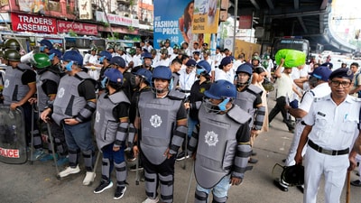 Policemen make a barricade to stop supporters of ruling Bharatiya Janata Party staging a protest overthe alleged rape of a student at the South Calcutta Law College campus on Wednesday, in Kolkata. (AP) Policemen make a barricade to stop supporters of ruling Bharatiya Janata Party staging a protest overthe alleged rape of a student at the South Calcutta Law College campus on Wednesday, in Kolkata. (AP)
