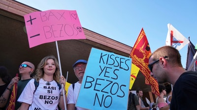 Activists were seen holding "kisses yes, Bezos No' posters against wedding between Jeff Bezos and his wife Lauren Sanchez Bezos that took place in Venice on Friday.. (AP Photo/Antonio Calanni) (AP) Activists were seen holding "kisses yes, Bezos No' posters against wedding between Jeff Bezos and his wife Lauren Sanchez Bezos that took place in Venice on Friday.. (AP Photo/Antonio Calanni) (AP)