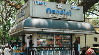Customers at a Nandini milk shop in Bengaluru. (PTI) Customers at a Nandini milk shop in Bengaluru. (PTI)
