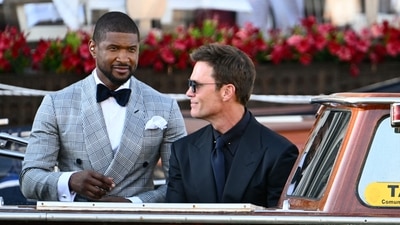 Best Dressed: Singer Usher stunned in a neutral ensemble, pairing a black and white patterned suit jacket with a bow tie and a crisp white pocket square for a flawless finish.Worst Dressed: Tom Brady donned a boring all black suit with matching tie for the wedding. (Photo by Stefano Rellandini / AFP) (AFP) Best Dressed: Singer Usher stunned in a neutral ensemble, pairing a black and white patterned suit jacket with a bow tie and a crisp white pocket square for a flawless finish.Worst Dressed: Tom Brady donned a boring all black suit with matching tie for the wedding. (Photo by Stefano Rellandini / AFP) (AFP)