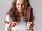 Dermatologist explains that hair loss of 100-200 strands daily is normal.