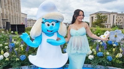 At the premiere, Rihanna linked arms with, hugged someone dressed as her cartoon alter-ego and flaunted her baby bump in a blue dress, which she paired with diamond earrings. At the premiere, Rihanna linked arms with, hugged someone dressed as her cartoon alter-ego and flaunted her baby bump in a blue dress, which she paired with diamond earrings. 
