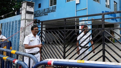 Policemen stand guard outside South Calcutta Law College after the rape of a student on the college campus. (Source: PTI) (AP) Policemen stand guard outside South Calcutta Law College after the rape of a student on the college campus. (Source: PTI) (AP)