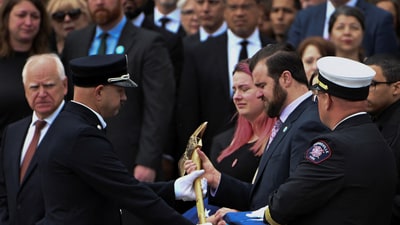 Colin Hortman, son of slain Minnesota lawmaker Melissa Hortman and her husband Mark, is presented a ceremonial firefighter ax after the funeral, two weeks after they were killed by a man impersonating a police officer, at the Basilica of Saint Mary's in Minneapolis, Minnesota, U.S. June 28, 2025.  REUTERS/Craig Lassig (REUTERS)