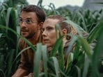 This image released by Universal Pictures and Amblin Entertainment shows Jonathan Bailey, Left, and and Scarlett Johansson in a scene from " Jurassic World: Rebirth." 