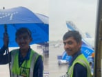 Video of IndiGo staffer Arun Charan helping passengers in rain goes viral. Video of IndiGo staffer Arun Charan helping passengers in rain goes viral.