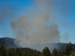 Smoke rises after multiple firefighters were attacked when responding to a fire in the Canfield Mountain area outside Coeur d’Alene, Idaho, U.S. June 29, 2025.  
