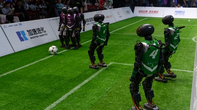 Robots battling it out in the field at the inaugural RoBoLeague robot soccer competition held in Beijing, Saturday, June 28, 2025. ((AP Photo/Ng Han Guan)) Robots battling it out in the field at the inaugural RoBoLeague robot soccer competition held in Beijing, Saturday, June 28, 2025. ((AP Photo/Ng Han Guan))