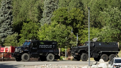 Armored law enforcement vehicles are seen at Cherry Hill Park after multiple firefighters were attacked when responding to a fire in the Canfield Mountain area (REUTERS)