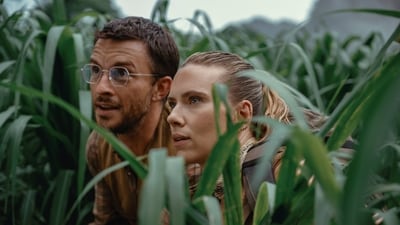 This image released by Universal Pictures and Amblin Entertainment shows Jonathan Bailey, Left, and and Scarlett Johansson in a scene from " Jurassic World: Rebirth." (Universal Pictures and Amblin Entertainment via AP)