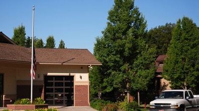 An American flag flies at half-staff outside the Coeur d’Alene Fire Department, honoring firefighters killed in a Canfield Mountain ambush on June 30, 2025. (AP Photo/Lindsey Wasson) (AP) An American flag flies at half-staff outside the Coeur d’Alene Fire Department, honoring firefighters killed in a Canfield Mountain ambush on June 30, 2025. (AP Photo/Lindsey Wasson) (AP)