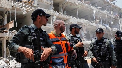 Israeli security forces stand guard at the site of an Iranian strike that hit a residential neighbourhood in the Ramat Aviv area in Tel Aviv. (AFP) Israeli security forces stand guard at the site of an Iranian strike that hit a residential neighbourhood in the Ramat Aviv area in Tel Aviv. (AFP)
