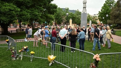 Members of a church gather for prayer beside a memorial at the scene of an attack that injured multiple people, outside the Boulder County Courthouse, in Boulder, Colorado on June 2, 2025. (REUTERS)