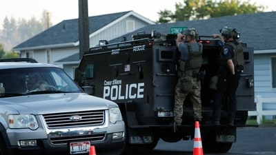 An armored police vehicle was seen exiting the area after the ambush on firefighters responding to the blaze near Canfield Mountain. The area is under a high-security presence. REUTERS/Young Kwak (REUTERS)