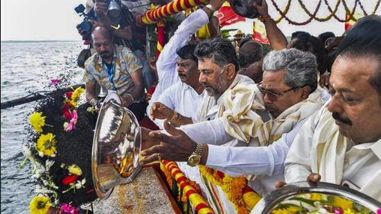 Chief Minister Siddaramaiah with Deputy Chief Minister D.K. Shivakumar offers the customary 'bagina' to the Cauvery river, at Krishnaraja Sagar (KRS) dam in Mandya district of Karnataka, on Monday (PTI)
