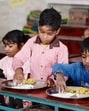 Students at a basic primary school in Gosainganj area enjoying kheer in lunch as schools reopened on Tuesday after the summer vacation. (Deepak Gupta/HT Photo) Students at a basic primary school in Gosainganj area enjoying kheer in lunch as schools reopened on Tuesday after the summer vacation. (Deepak Gupta/HT Photo)