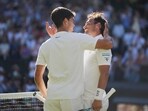 Carlos Alcaraz, left, greets Fabio Fognini at the net after winning their first round men's singles match at the Wimbledon Championships in London Carlos Alcaraz, left, greets Fabio Fognini at the net after winning their first round men's singles match at the Wimbledon Championships in London