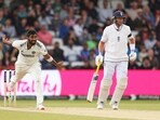 India's Jasprit Bumrah, left, reacts after bowling a delivery