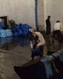 Workers at the inundated godown on Monday. (HT Photo) Workers at the inundated godown on Monday. (HT Photo)