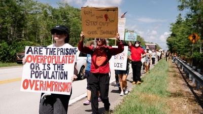 Demonstrators protest the construction of a detention center, nicknamed "Alligator Alcatraz," in the Everglades near Ochopee, Florida, on Tuesday, July 1, 2025. The state-run facility is the first of its kind, with Governor Ron DeSantis pushing for a high-profile role in Donald Trump's immigration dragnet, and has raised concerns about detention standards and the ability to meet federal requirements. Photographer: Martina Tuaty/Bloomberg (Bloomberg)
