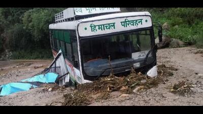 An HRTC bus stuck in the mudslide on road in Mandi district on Tuesday. (HT Photo)