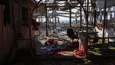 A Palestinian man inspect the damage at Al-Baqa cafeteria which was devastated in an Israeli strike on the Gaza City seafront on June 30. (AFP)
