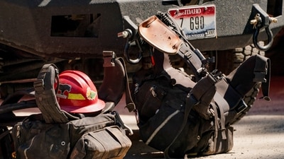Firefighting gear sits in a staging area near where two firefighters were shot dead while responding to a fire and the body of a man was later found with a gun nearby in the Canfield Mountain area outside Coeur d’Alene, Idaho, U.S. June 30, 2025.  REUTERS/David Ryder (REUTERS)