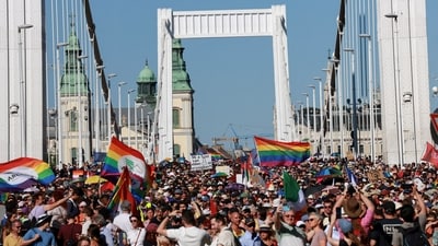 People cross the Elisabeth Bridge during the Budapest Pride March in Budapest, Hungary, (REUTERS)