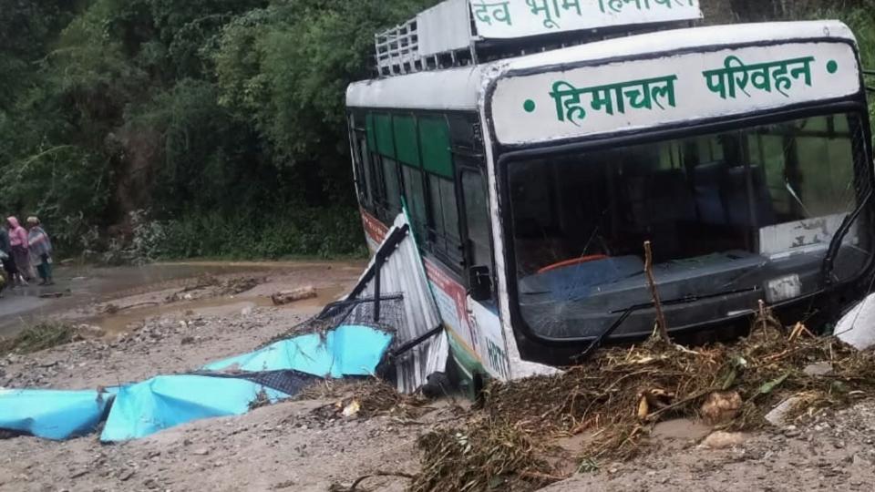A Himachal Pradesh Road Transport Corporation bus stuck in a mudslide at Janjehli in Mandi district on Tuesday. (HT Photo) A Himachal Pradesh Road Transport Corporation bus stuck in a mudslide at Janjehli in Mandi district on Tuesday. (HT Photo)