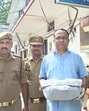 The conman in Hazratganj police custody on Wednesday. (HT Photo)