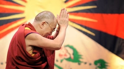 Tibetan spiritual leader the Dalai Lama gestures in front of the flag of Tibet in this photo from 2008. He is close to 90 now, and has confirmed that he will have a successor when he dies. (AFP File)